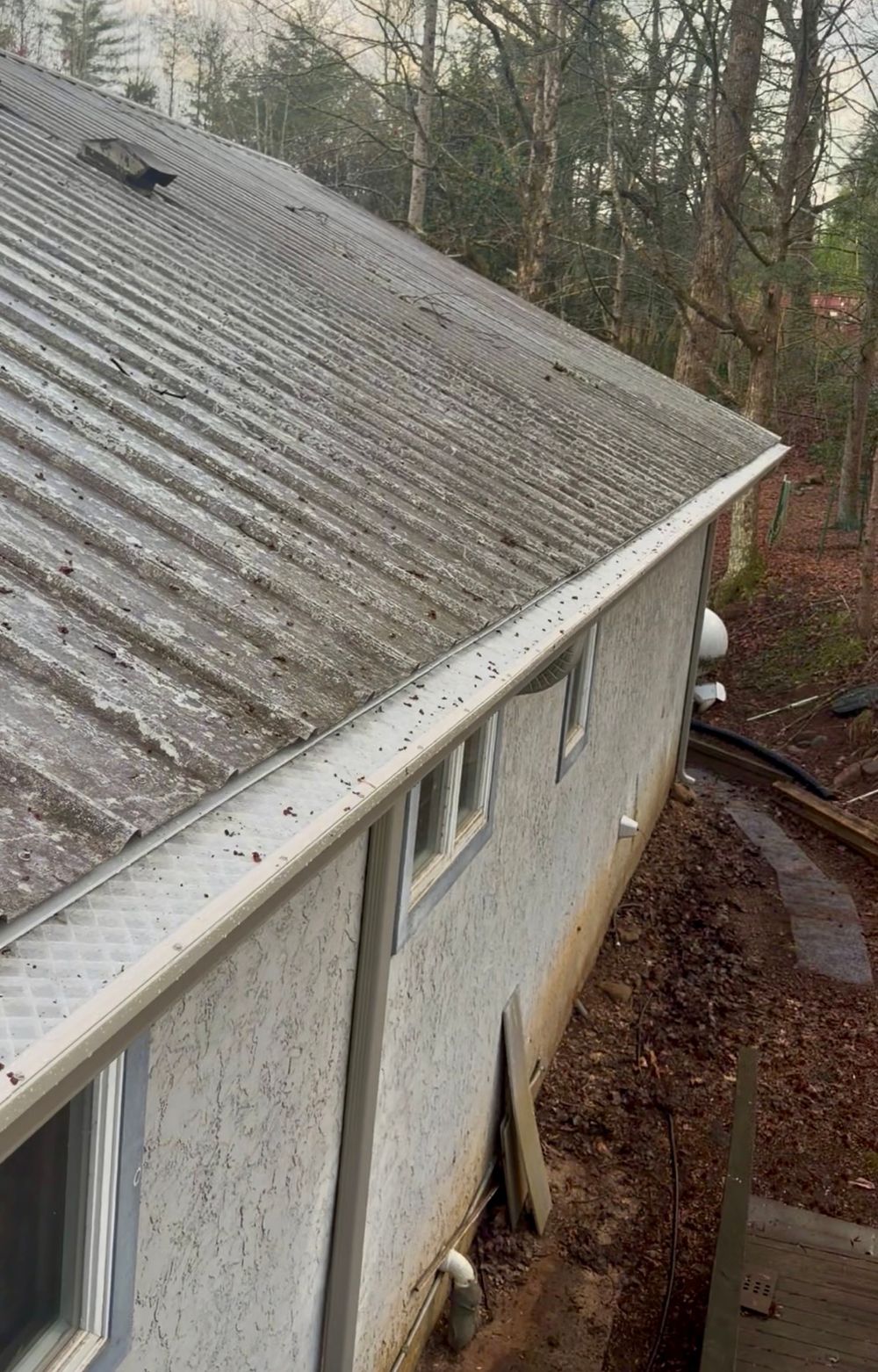 Aging gutter run on a weathered Upstate home before cleaning, resealing and re-pitching